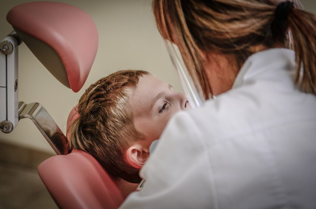 Dentist in Conroe, TX examining a teenagers teeth